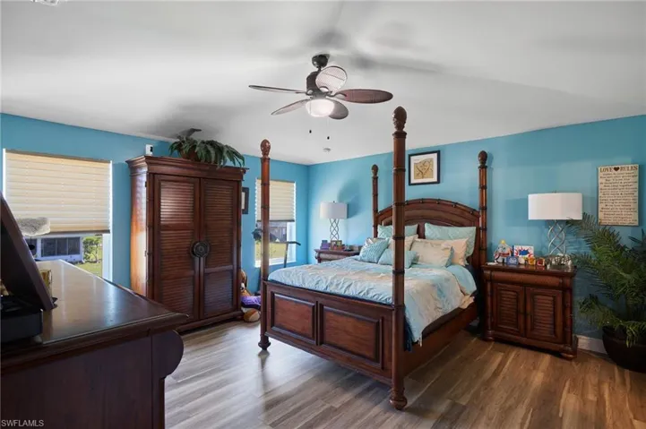 Bedroom featuring ceiling fan and hardwood / wood-style flooring