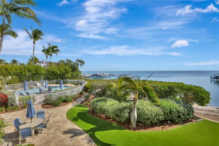 View of community with a patio area and a water view