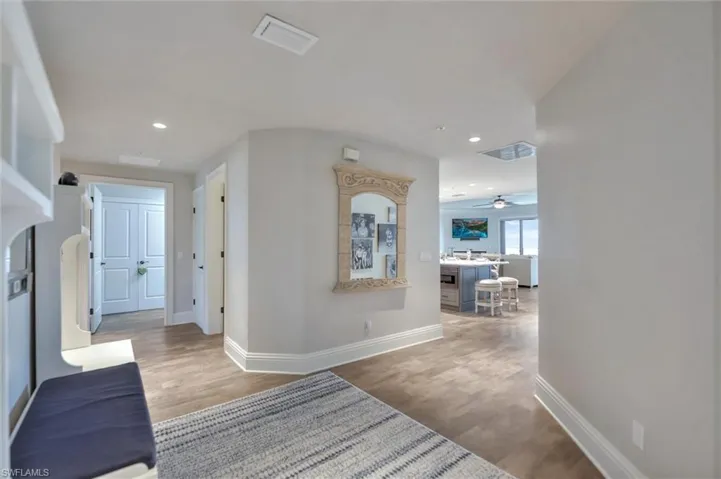 Corridor featuring light wood-style floors and recessed lighting