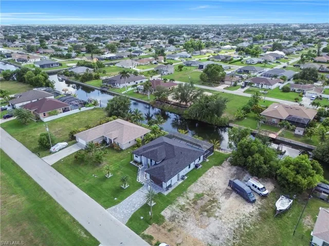 Aerial view of residential area featuring a nearby body of water