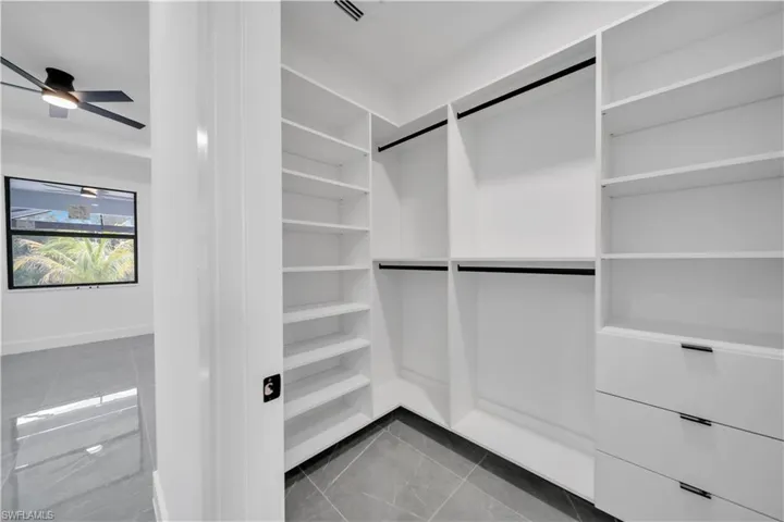 Walk in closet with tile patterned floors