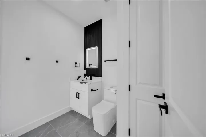 Bathroom with vanity and marble look tile flooring