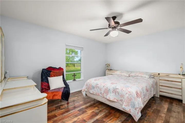 Bedroom featuring dark wood-style floors and a ceiling fan