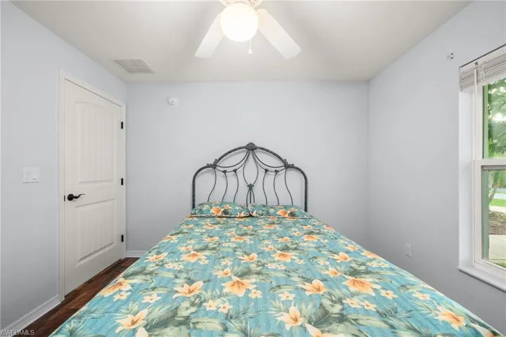 Bedroom with a ceiling fan and dark wood-style floors