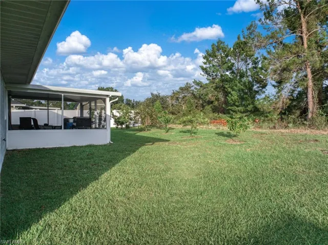 View of green lawn with a sunroom