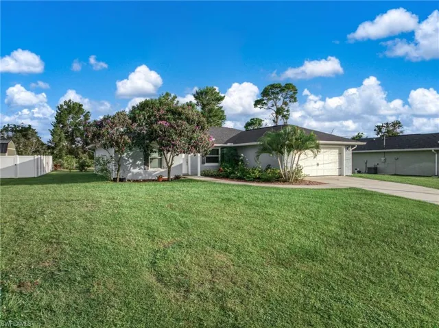 Single story home featuring driveway and an attached garage