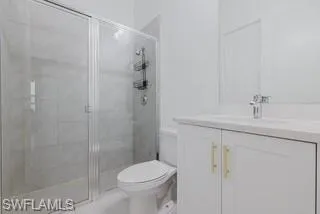 Bathroom featuring a stall shower and vanity