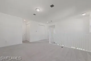 Spare room with light colored carpet