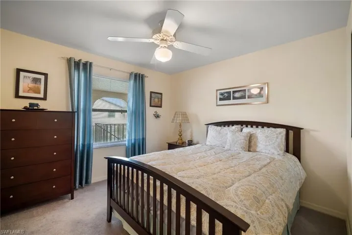 Bedroom with light carpet and ceiling fan