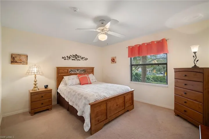 Carpeted bedroom with ceiling fan