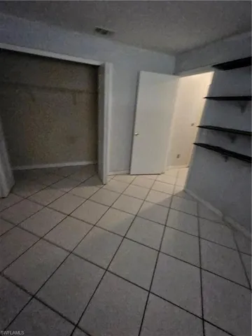 Unfurnished bedroom with tile patterned floors