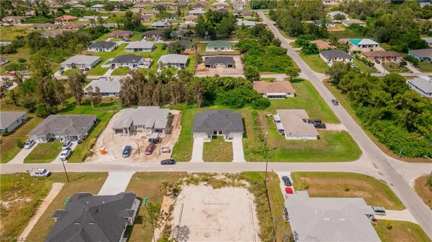 Aerial view of property and surrounding area featuring nearby suburban area