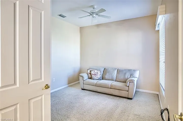 Living room featuring carpet floors and ceiling fan
