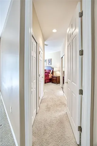 Hallway featuring carpet
