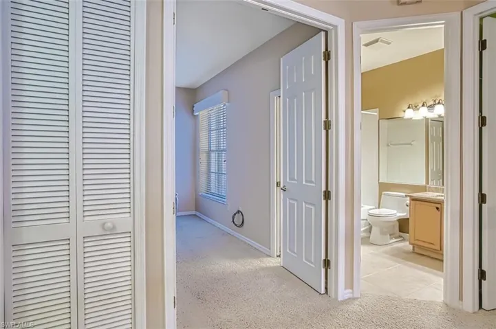 Hall featuring light tile patterned flooring