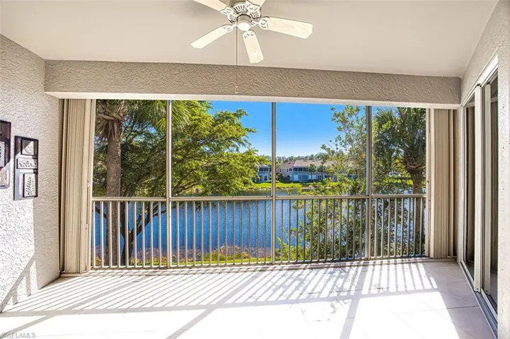 Unfurnished sunroom with ceiling fan