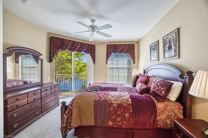 Carpeted bedroom with access to outside and ceiling fan