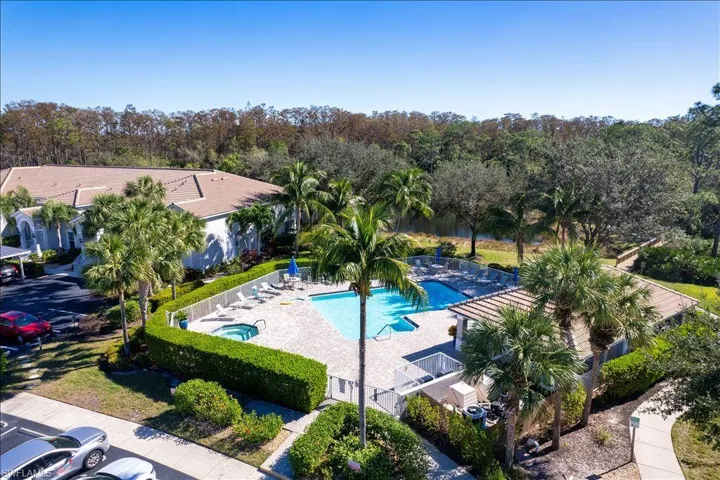 Community pool with fence and a patio area