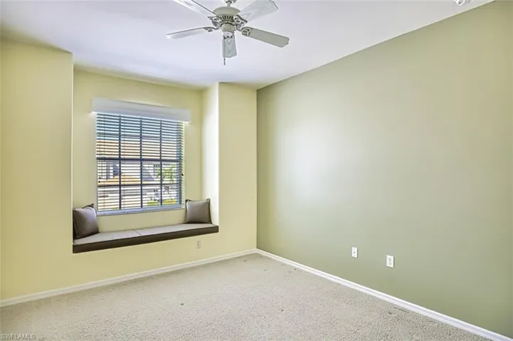 Carpeted spare room with ceiling fan