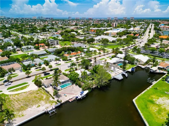 Birds eye view of property with a water view