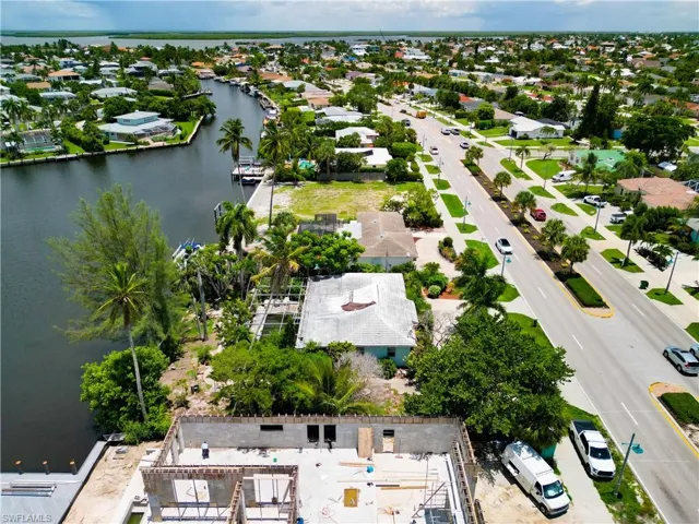 Birds eye view of property with a water view