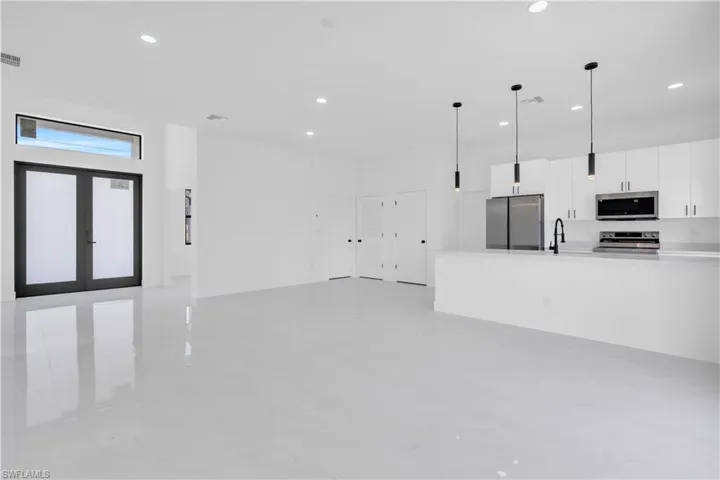 Unfurnished living room with a sink and recessed lighting