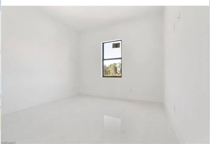Unfurnished room featuring baseboards
