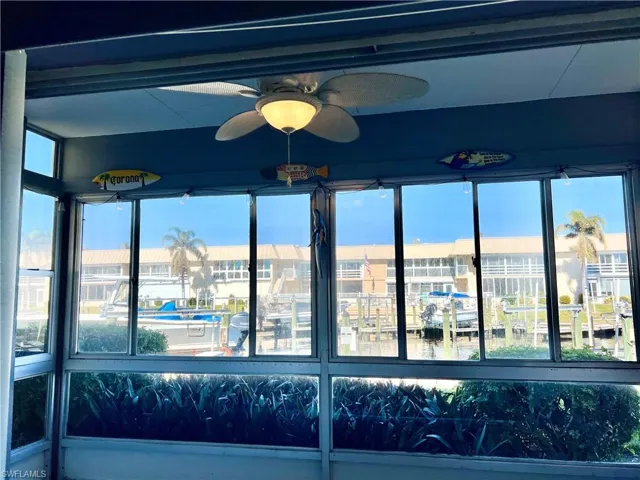 Sunroom with a healthy amount of sunlight and water view