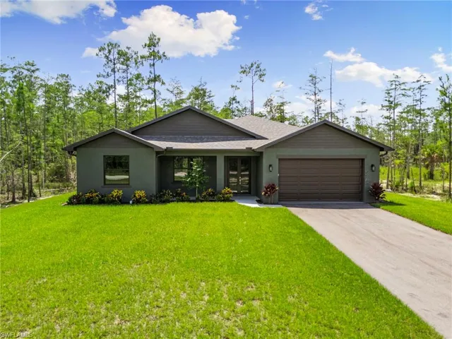 Contemporary single-story residence with a two-car garage, concrete driveway, and stucco exterior