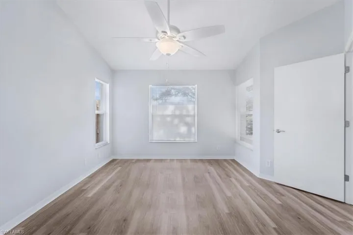 Unfurnished room featuring light wood-style flooring and a ceiling fan