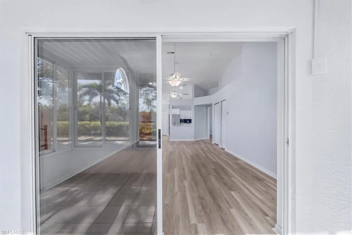 Unfurnished dining area featuring a ceiling fan, light wood-style flooring, and vaulted ceiling