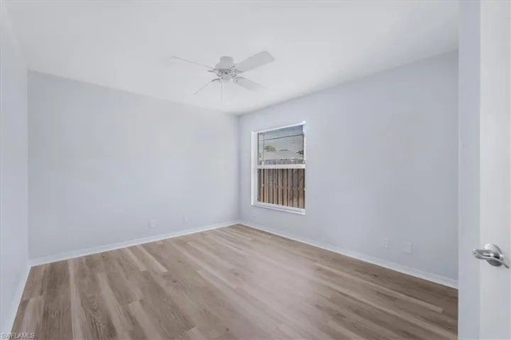 Empty room with light wood-style floors and a ceiling fan