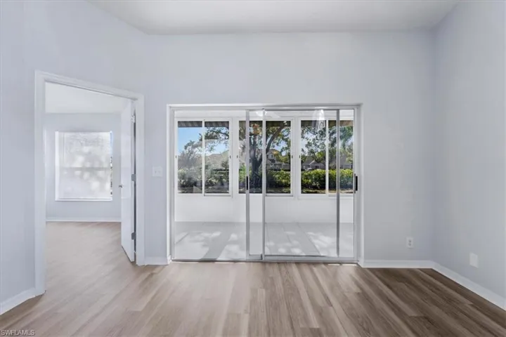Spare room featuring wood finished floors and baseboards