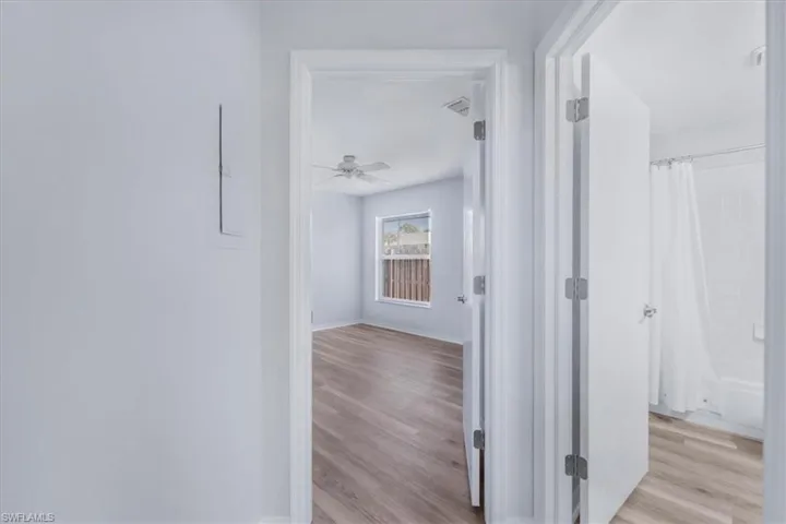 Corridor with light wood finished floors and baseboards