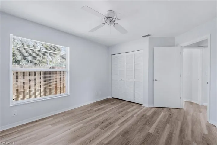 Unfurnished bedroom with a closet, a ceiling fan, and light wood-style floors