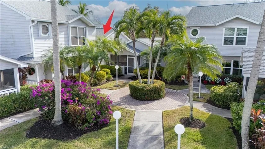 Surrounding community featuring a sunroom and a lawn