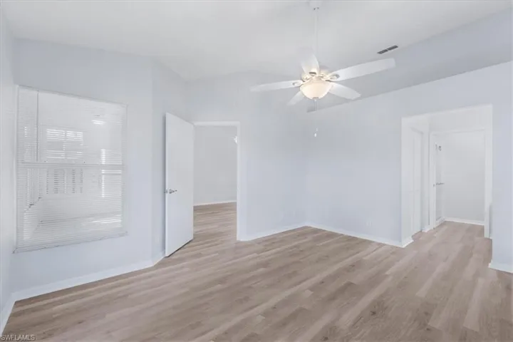 Unfurnished room with light wood-type flooring and a ceiling fan