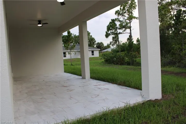 Spacious covered patio with concrete flooring and integrated ceiling fans