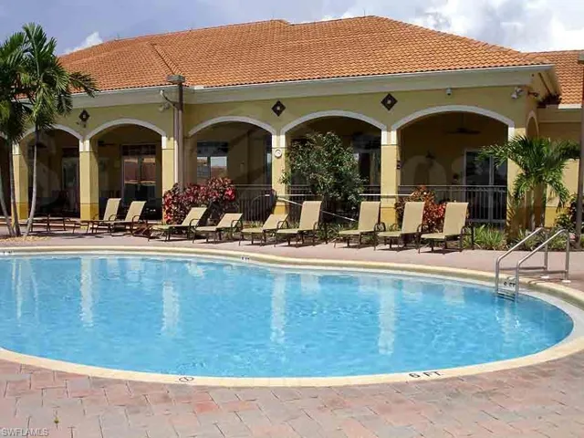Community pool with a patio
