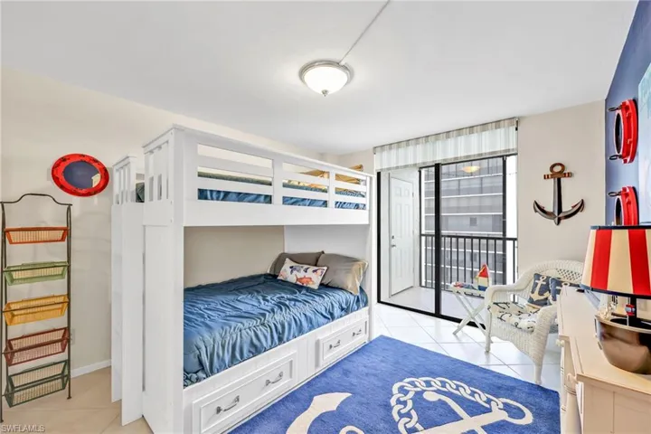 Bedroom with light tile patterned floors and access to exterior