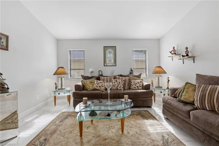 Living room with light marble finish floors and baseboards