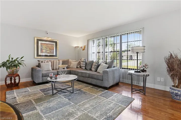 Living room with wood-type flooring and baseboards