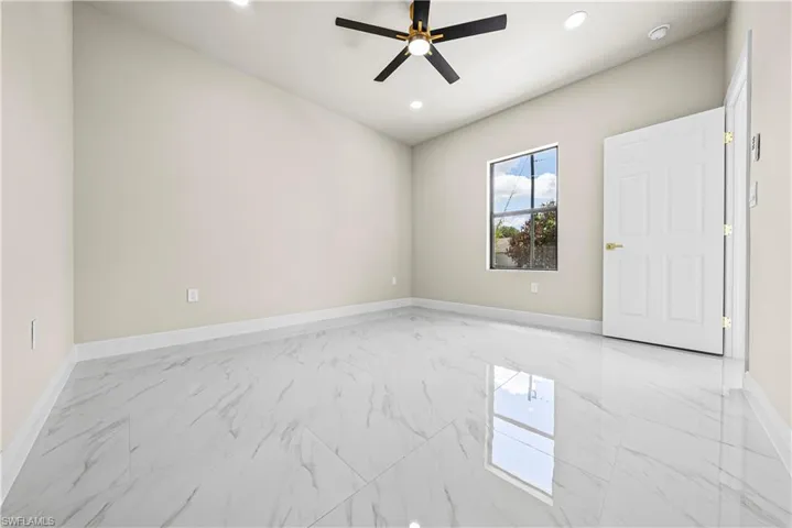 Empty room with light marble finish floors, recessed lighting, and ceiling fan