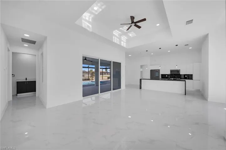 Unfurnished living room featuring visible vents, recessed lighting, baseboards, and ceiling fan