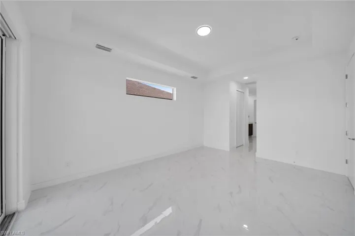 Unfurnished room with recessed lighting, a raised ceiling, baseboards, and visible vents