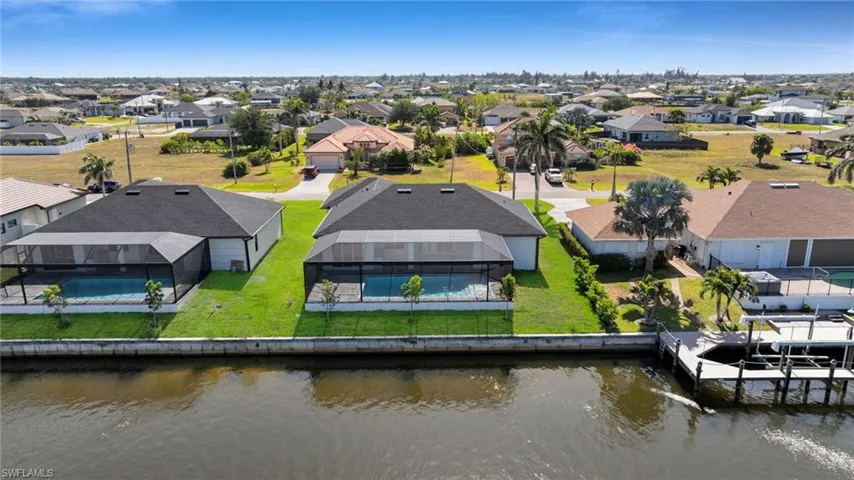 Birds eye view of property with a residential view and a water view