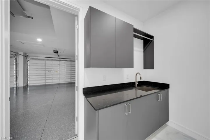Bar with a sink and baseboards