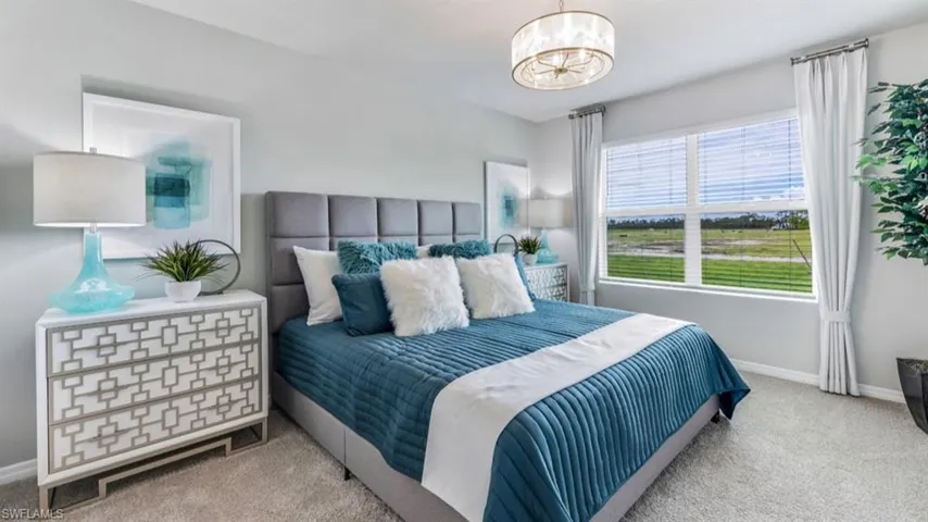 Carpeted bedroom with a chandelier