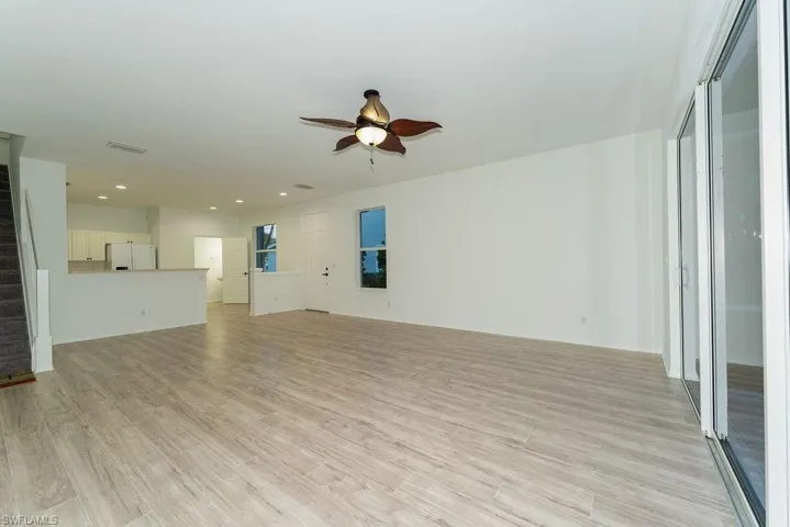 Unfurnished living room with light wood-type flooring, ceiling fan, recessed lighting, and a heating unit