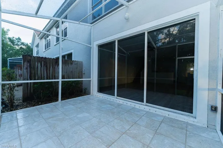 Unfurnished sunroom featuring a patio area